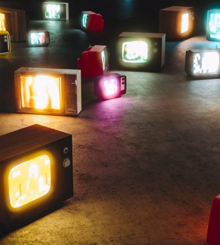 vintage televisions turned on the floor. Nobody around. 3d render. concept of mass media and tv addiction.